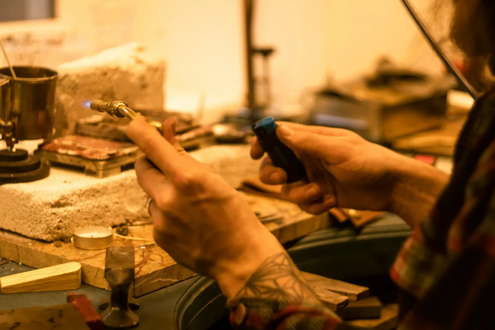 Hands working with a precision metalwork tool