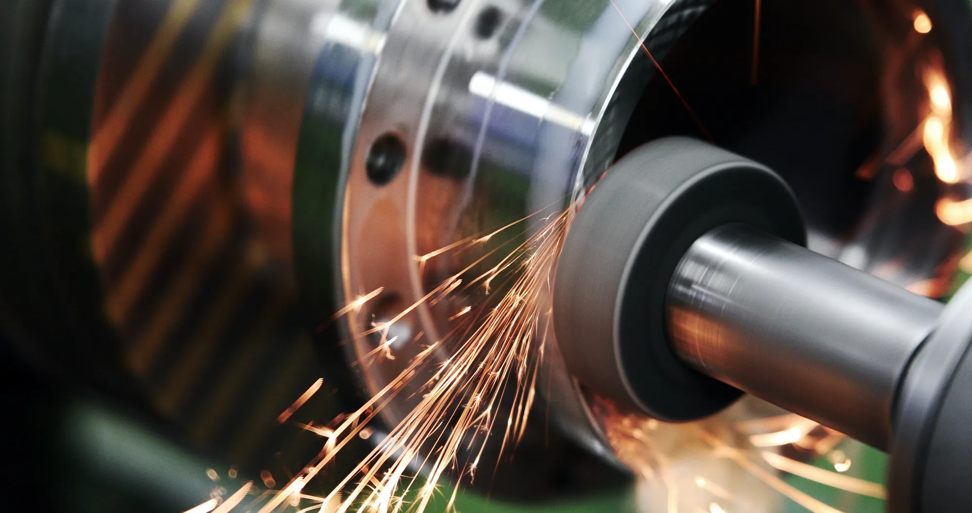A high-precision grinding machine finishing a metal component in the workshop